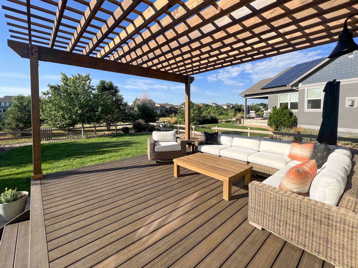 A patio with a wooden deck and a covered patio

Description automatically generated with medium confidence