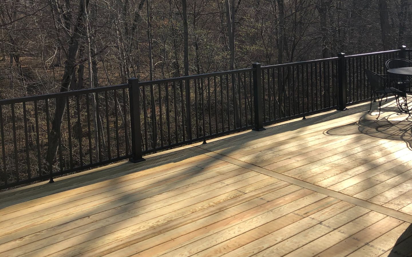 A deck with a black railing

AI-generated content may be incorrect.