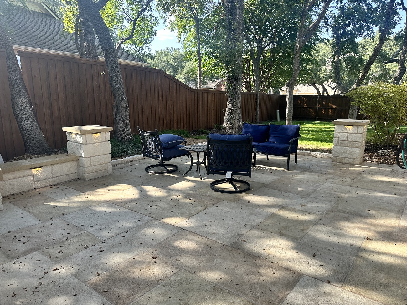 stone patio with stone columns and sitting area