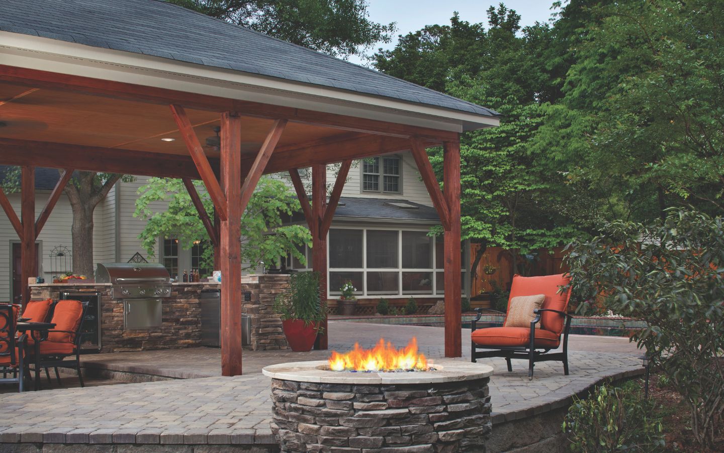 A fire pit with a chair in the back