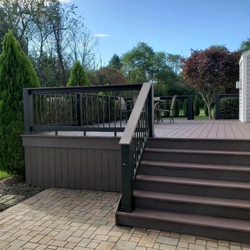 This AZEK redeck features a low-maintenance TimberTech Evolution rail complete with a AZEK top rail and additional drink rail.  