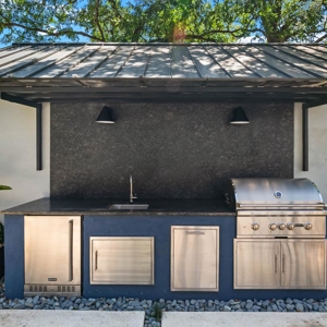 Outdoor kitchen with built-in grill and wet bar