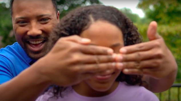 Father Playfully Holding Hands In Front of Daughter's Eyes