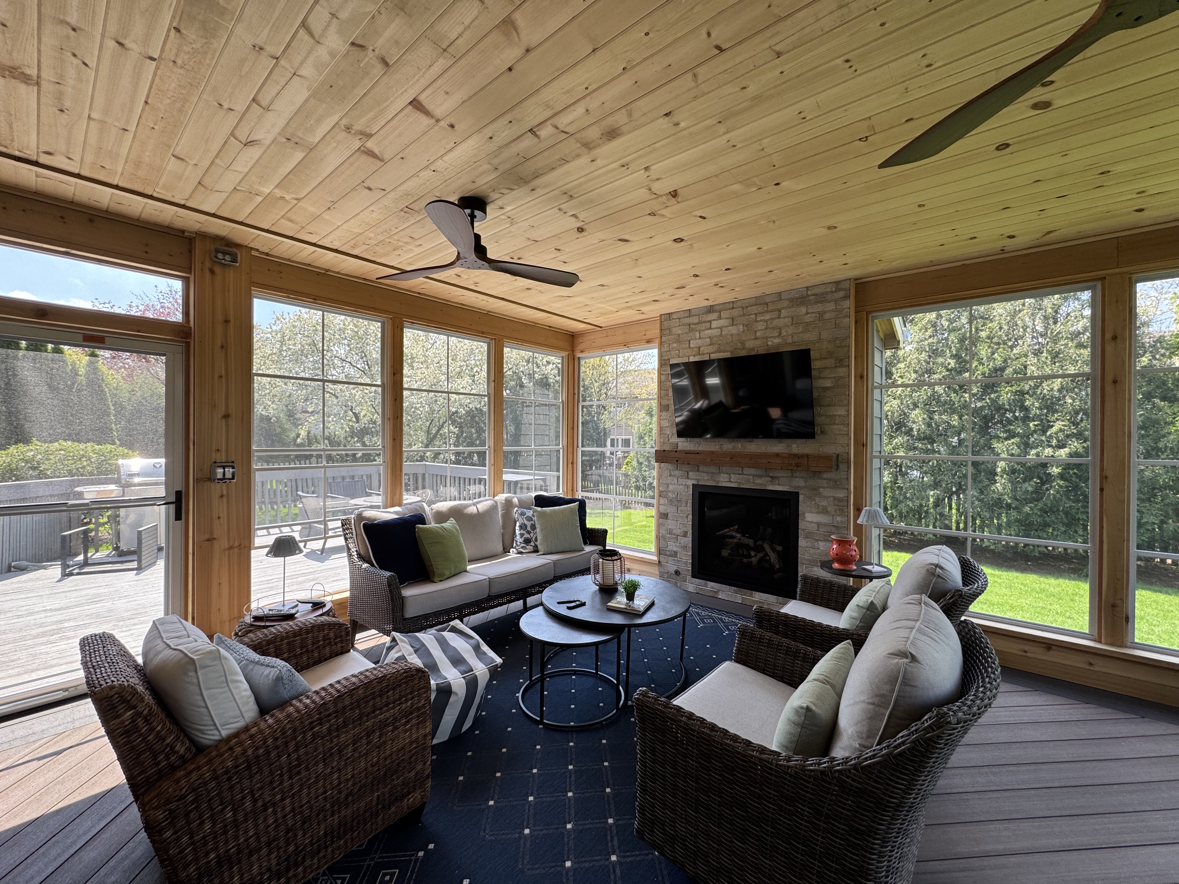 Custom 3-seaon room with fireplace and 4-track windows by Archadeck of Chicagoland-Naperville.