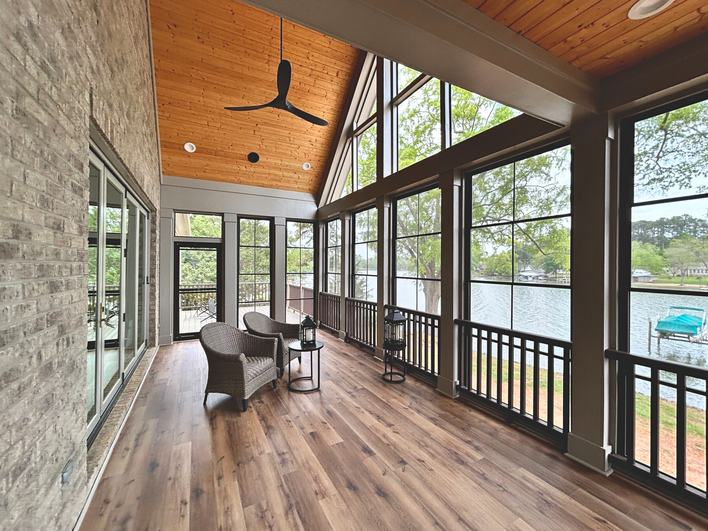 Custom sunroom design with gorgeous Eze-breeze windows, tall ceilings, overlooking a lake in charlotte, NC.