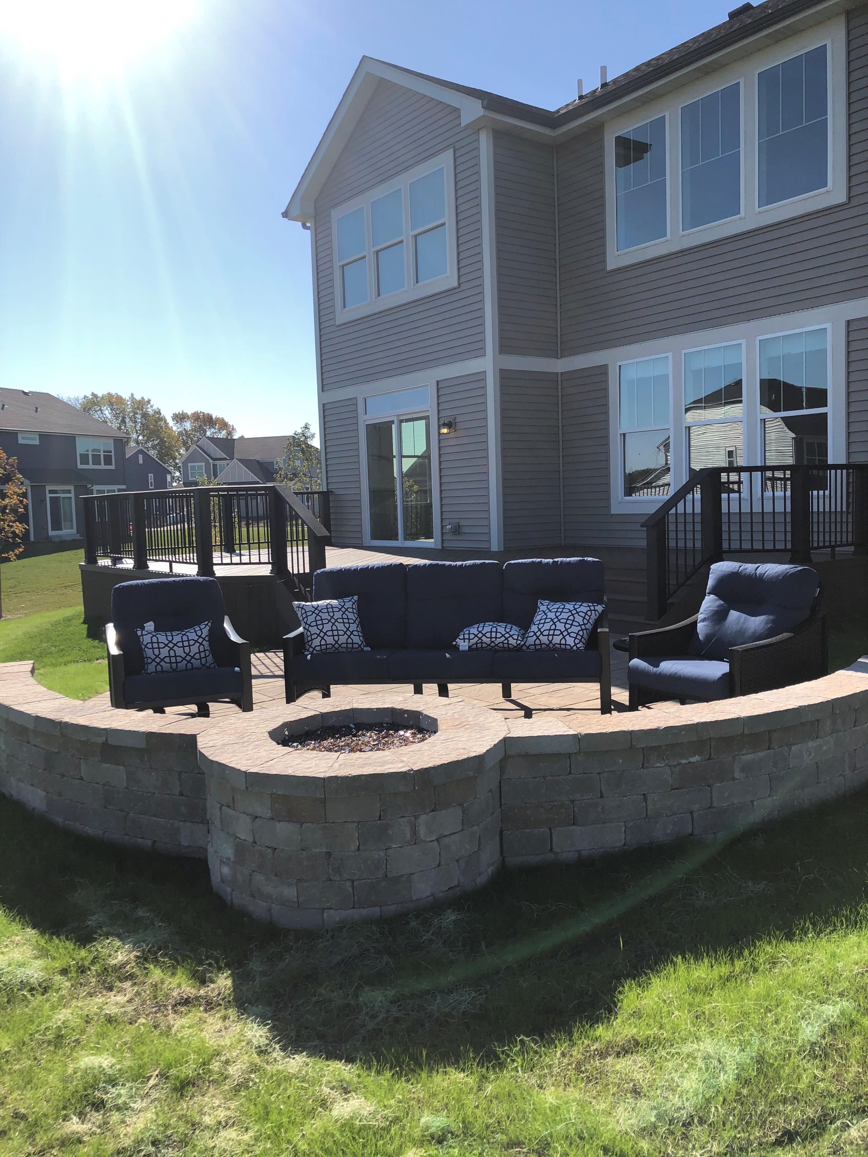 Composite deck and paver patio with firepit in Crystal Lake.
