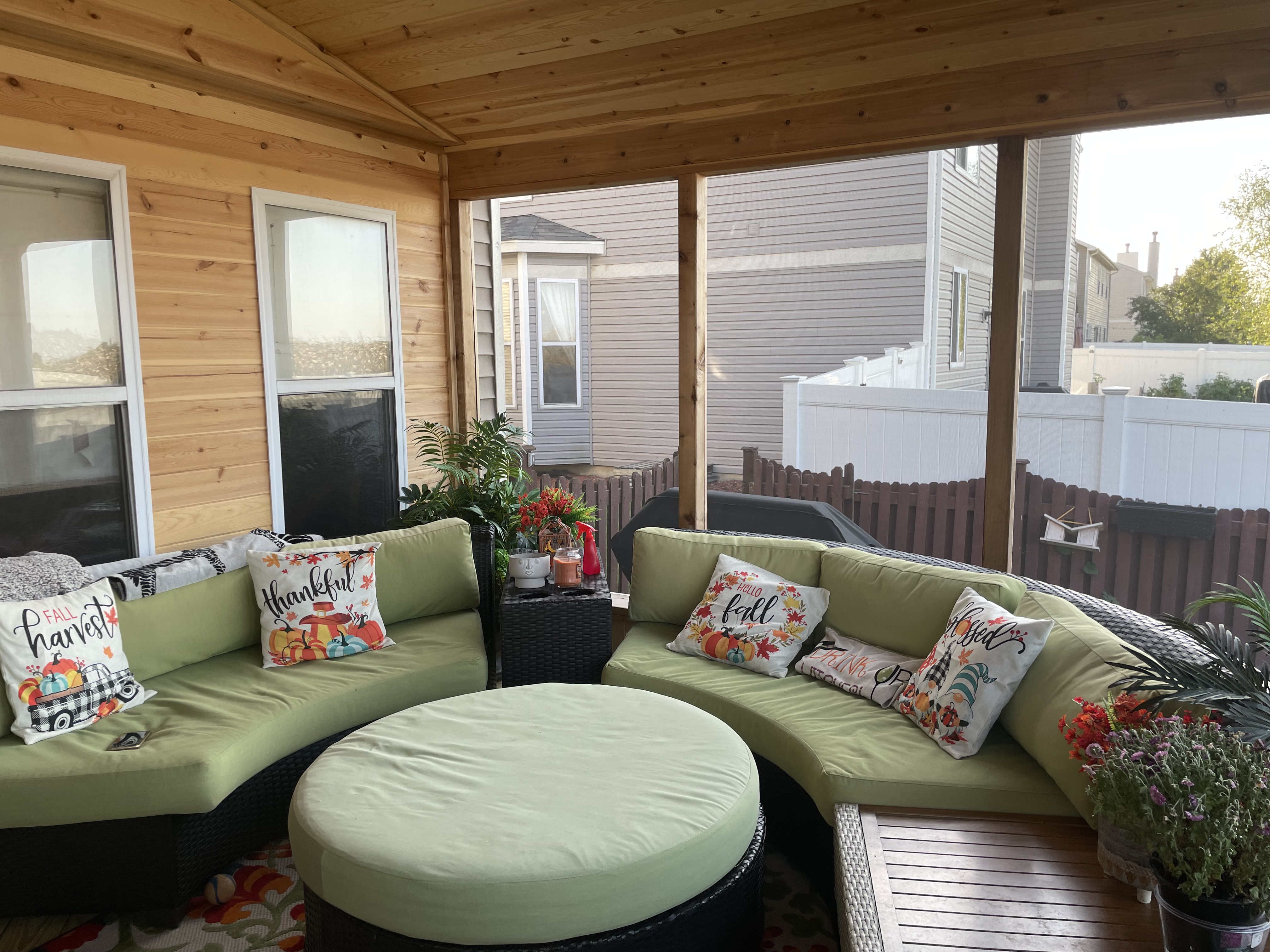 Inside of a screened porch with lounge couch and green cushions in Frankfort, IL.