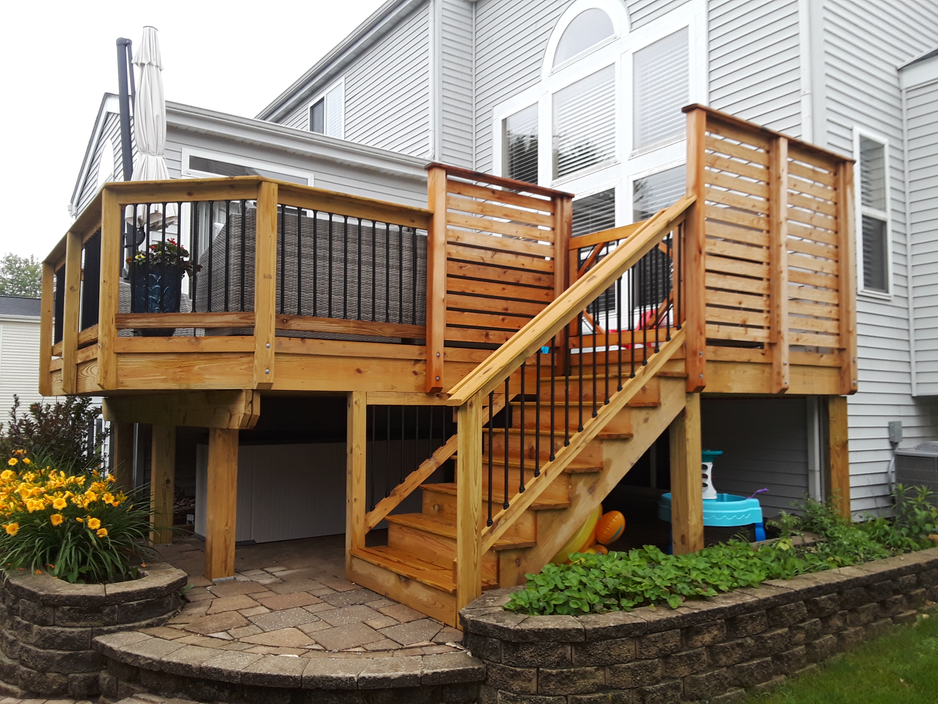 wood deck with privacy fence and hot tub by professional deck installers Archadeck of Chicagoland.
