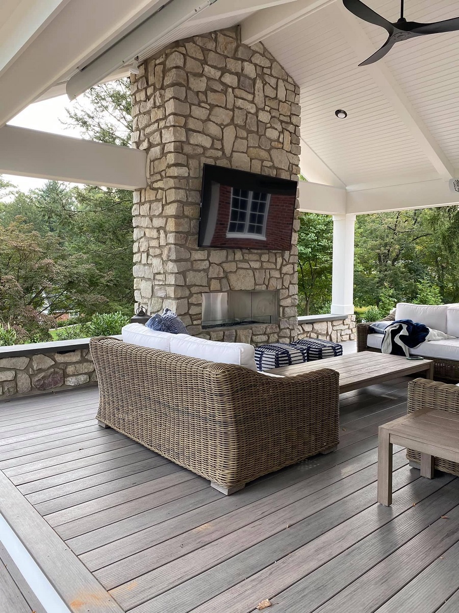 open porch with large stone fireplace