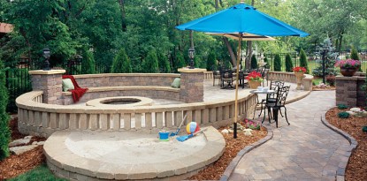 stone outdoor living space with fire feature