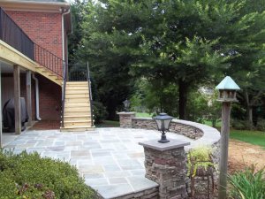 upgraded stone patio with upper deck