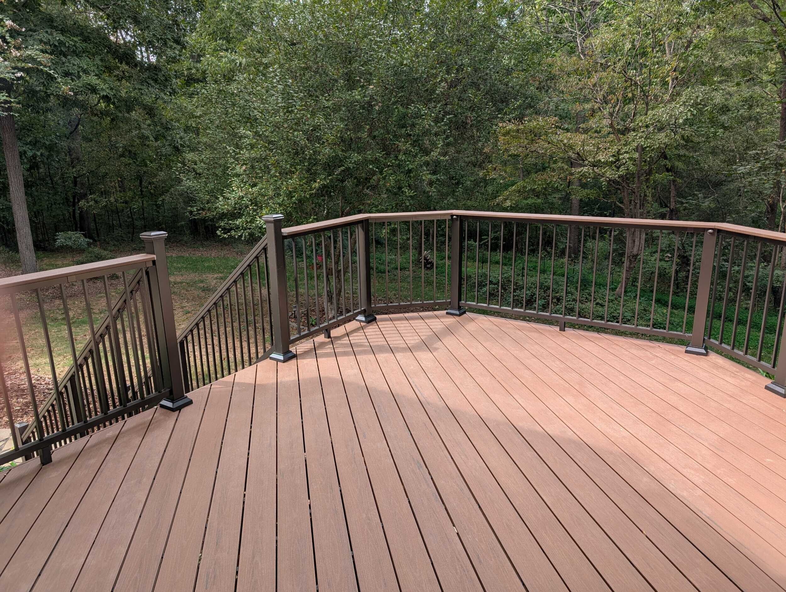 Custom brown composite deck with horizontal boards and vinyl rails in Monroe, NC.