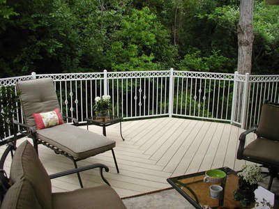 Raised deck with patio chairs and trees in background