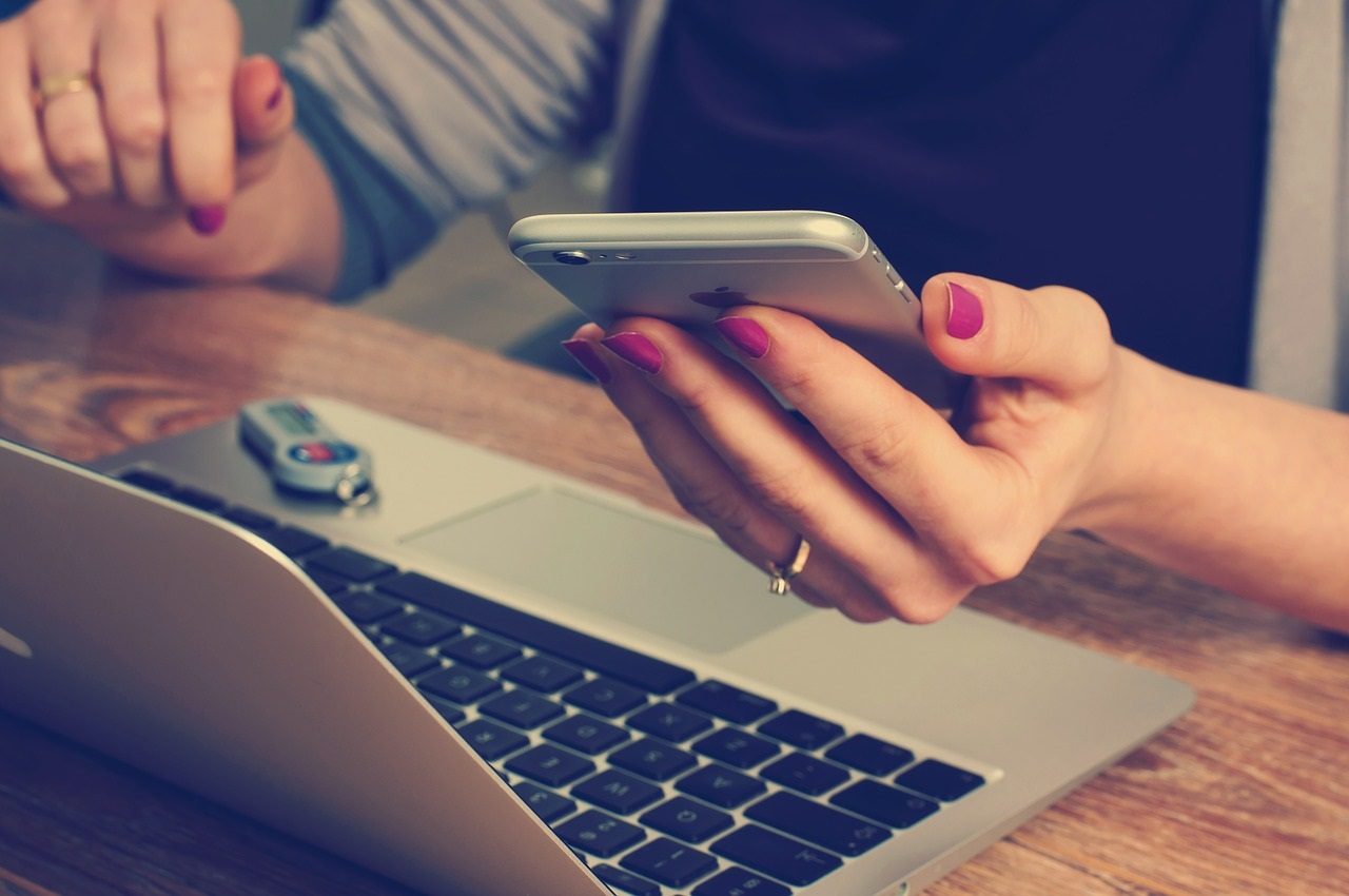 Woman on phone looking at budget