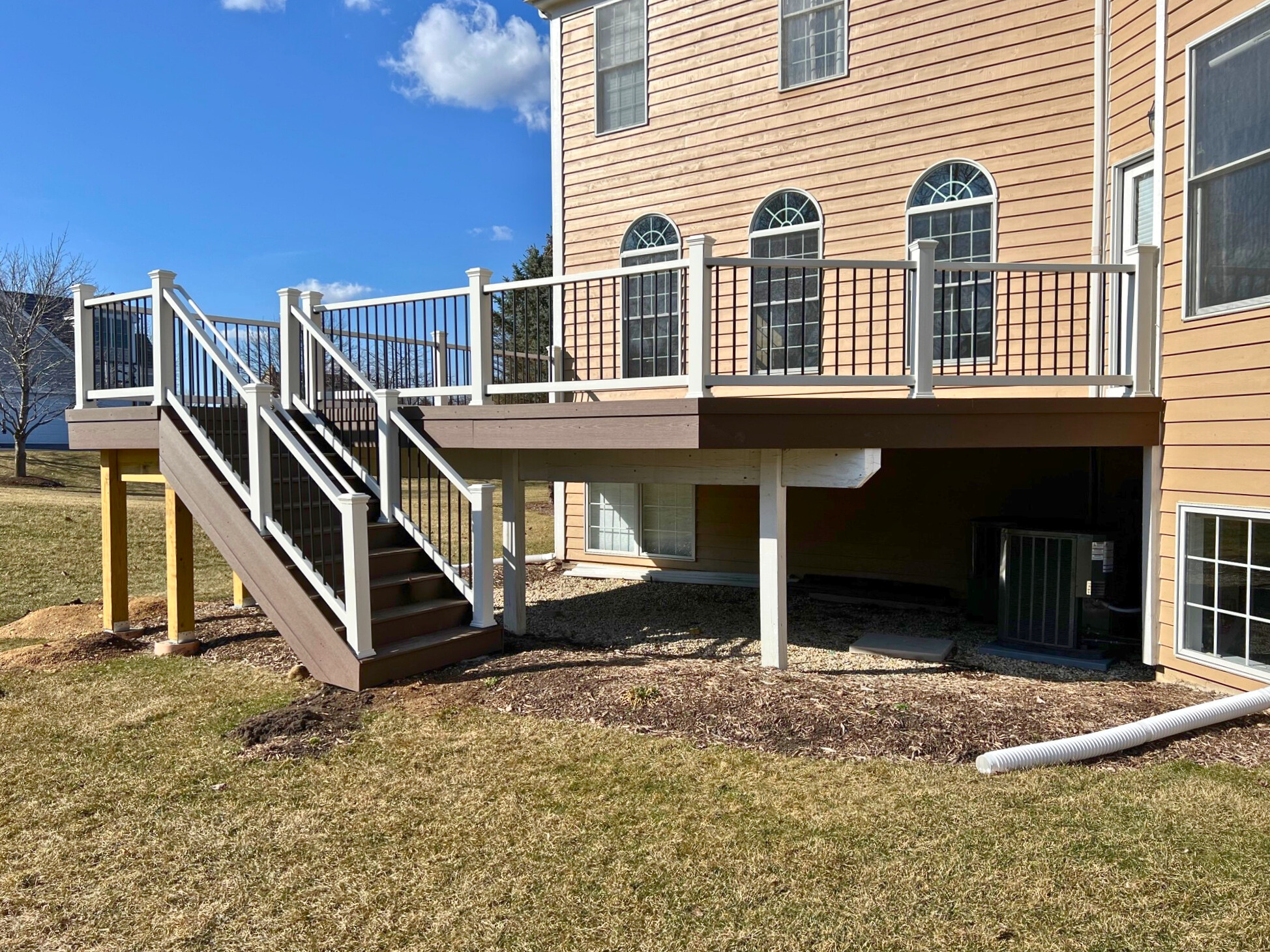 TimberTech deck in Crystal Lake, IL with white rails and black aluminum pickets