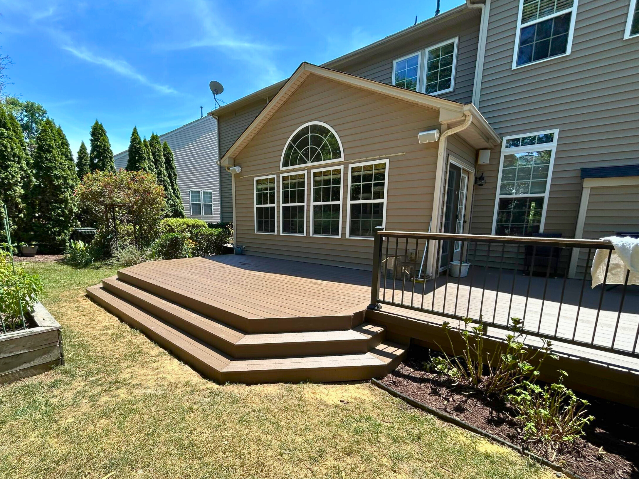 Composite deck in Huntersville NC with privacy screen, built by Archadeck of Charlotte.
