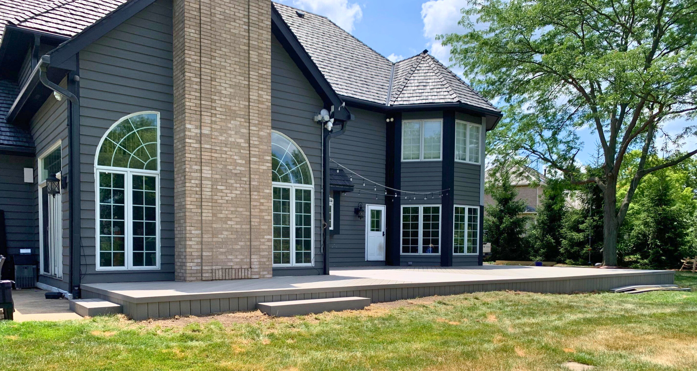 Back of a Long Grove home with a platform composite deck.