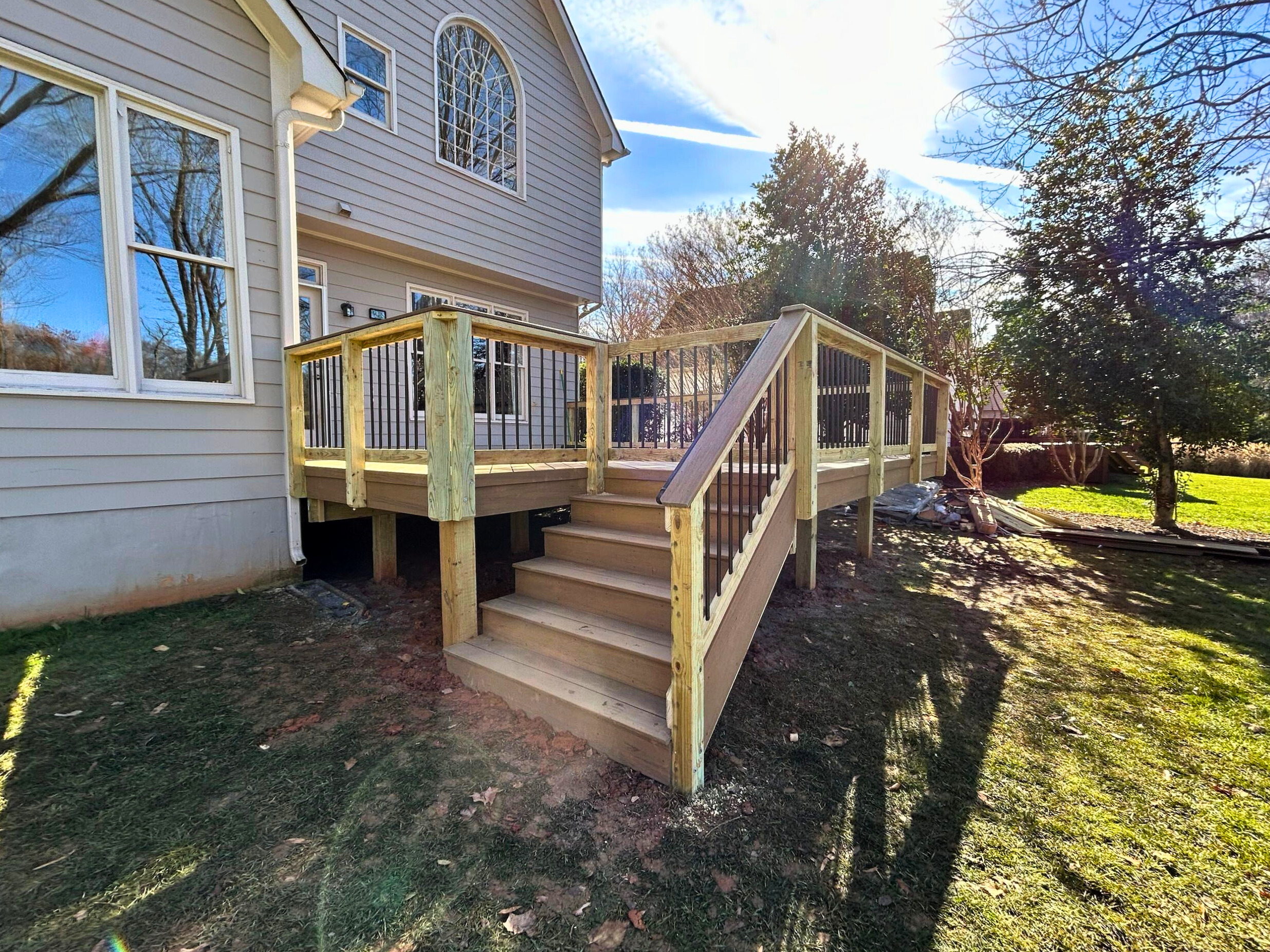 Custom-built composite deck with wide stairs in Huntersville NC.