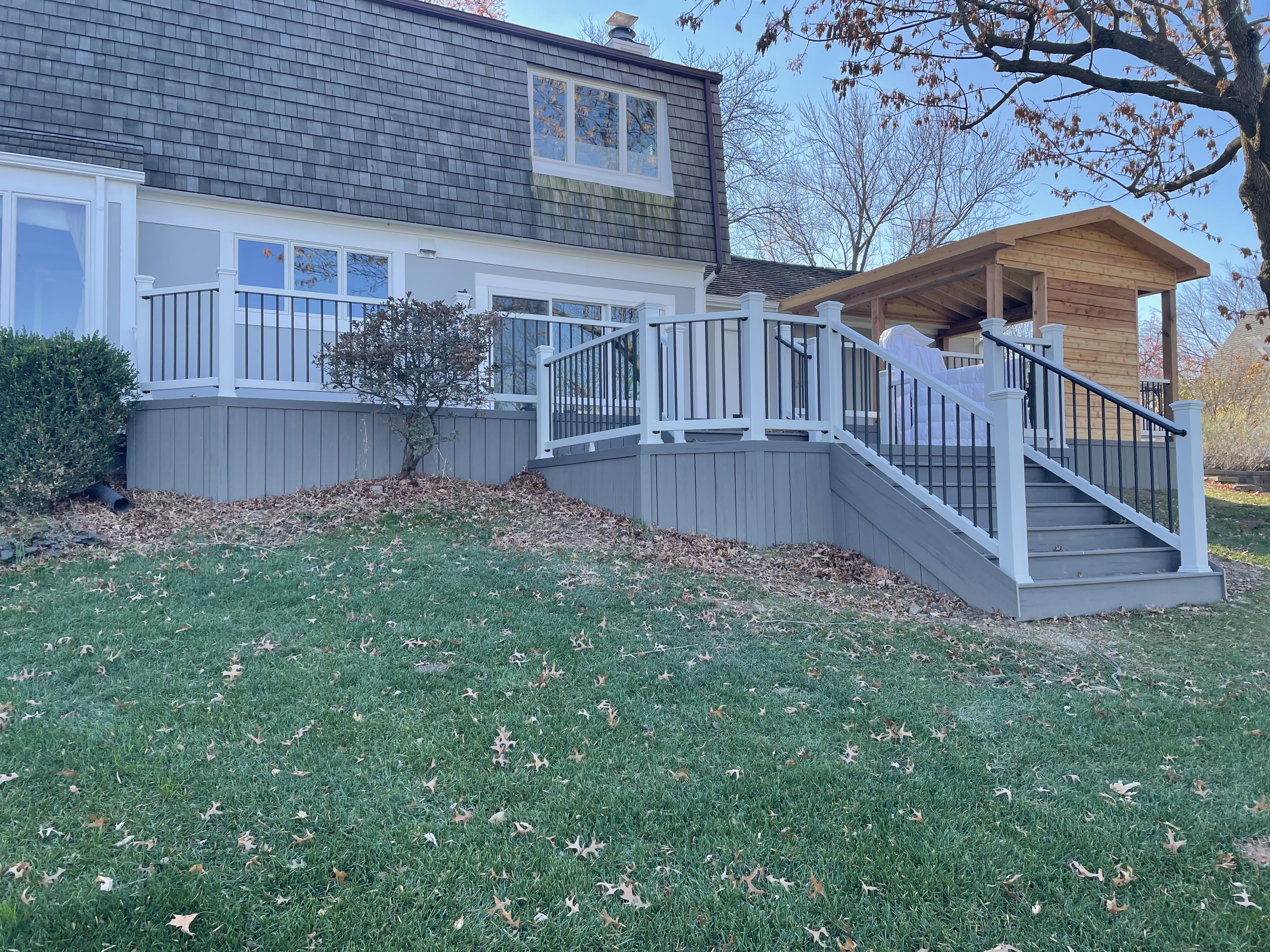 Multi-level composite deck with an open porch built by local deck builder Archadeck of Chicagoland.
