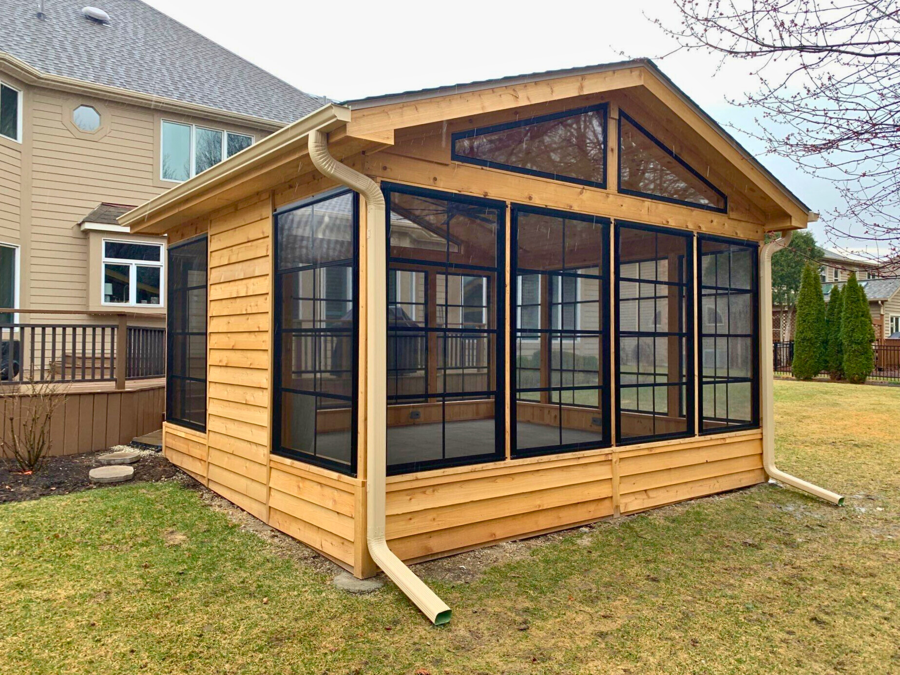 Enclosed patio with 4-track vinyl windows and privacy panel.