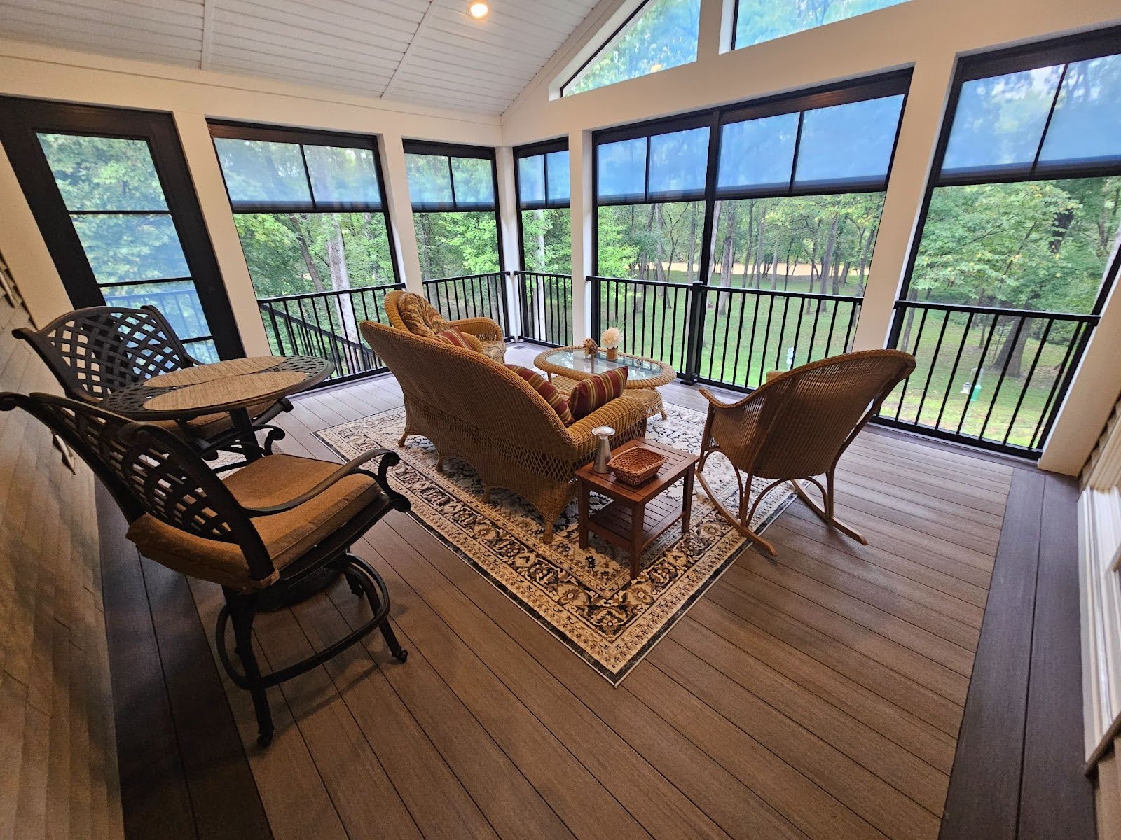 sunroom with wood flooring and seating area.