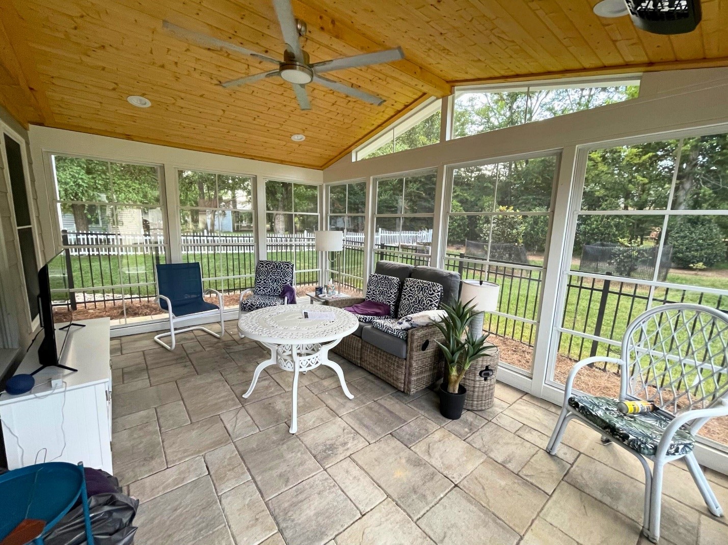 Enclosed porch with wood ceiling, tiles floors and large windows all around