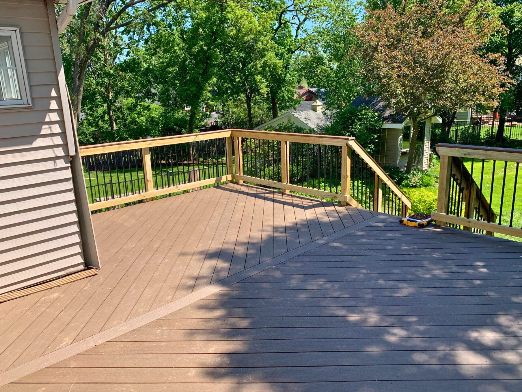 Brown Composite Deck with wood rails in Glen Ellyn, IL.