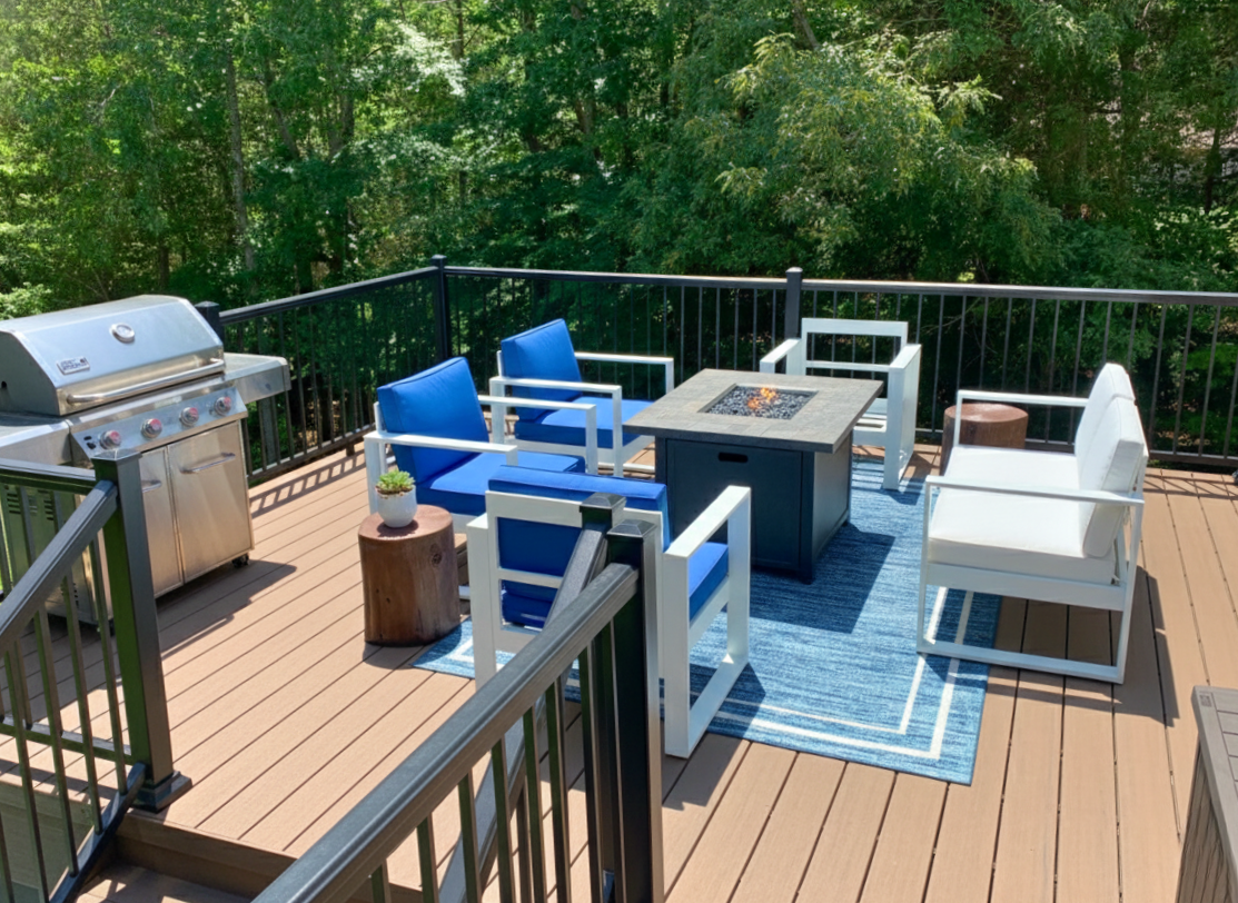 Custom composite deck in Harrisburg, NC with fire table and grill setup.