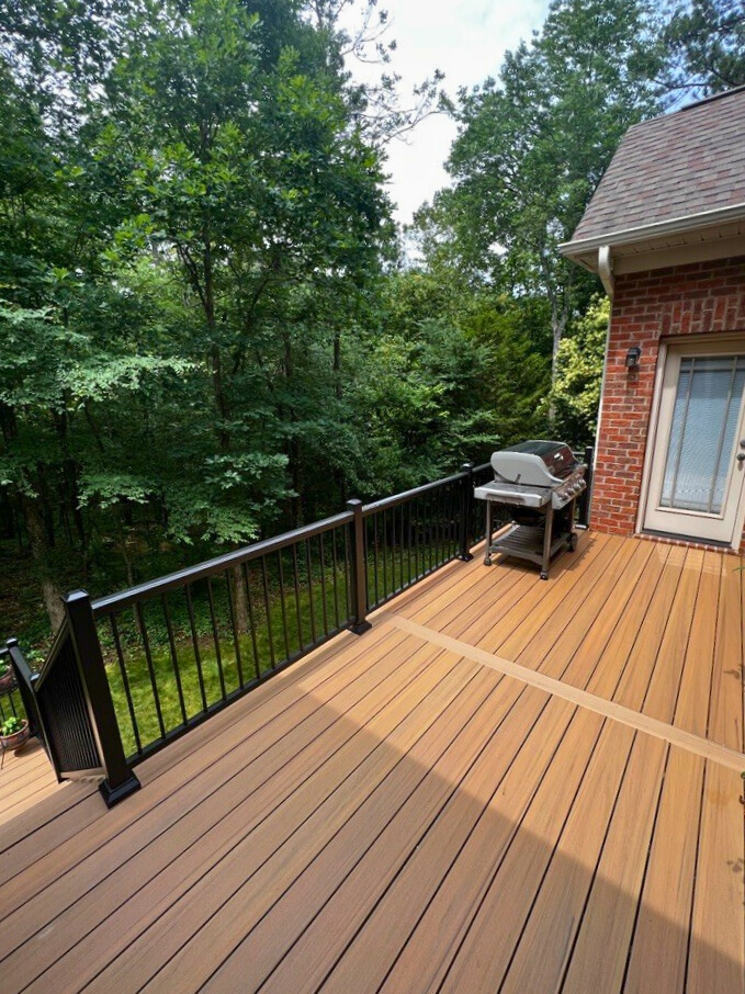 TimberTech deck overlooking tall green trees in Mooresville, NC.