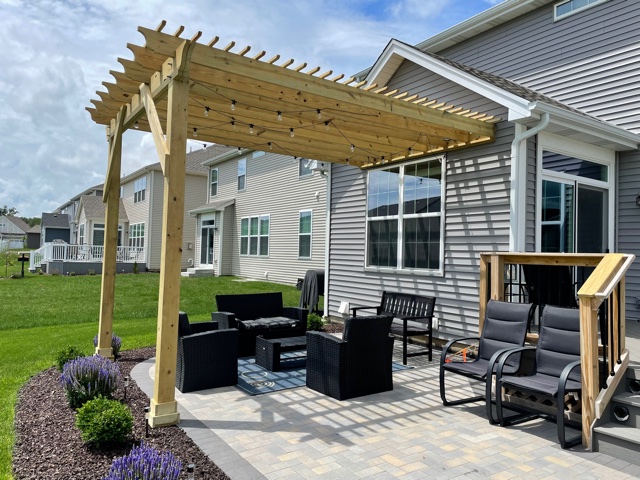 attached wood pergola over paver patio