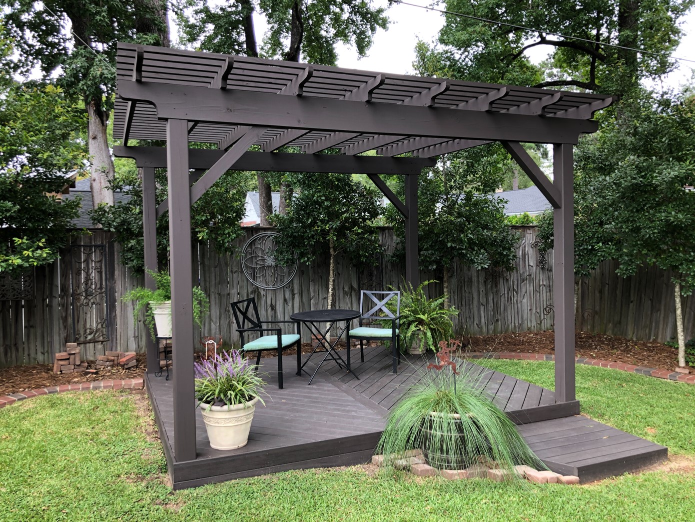 painted black pergola in a backyard