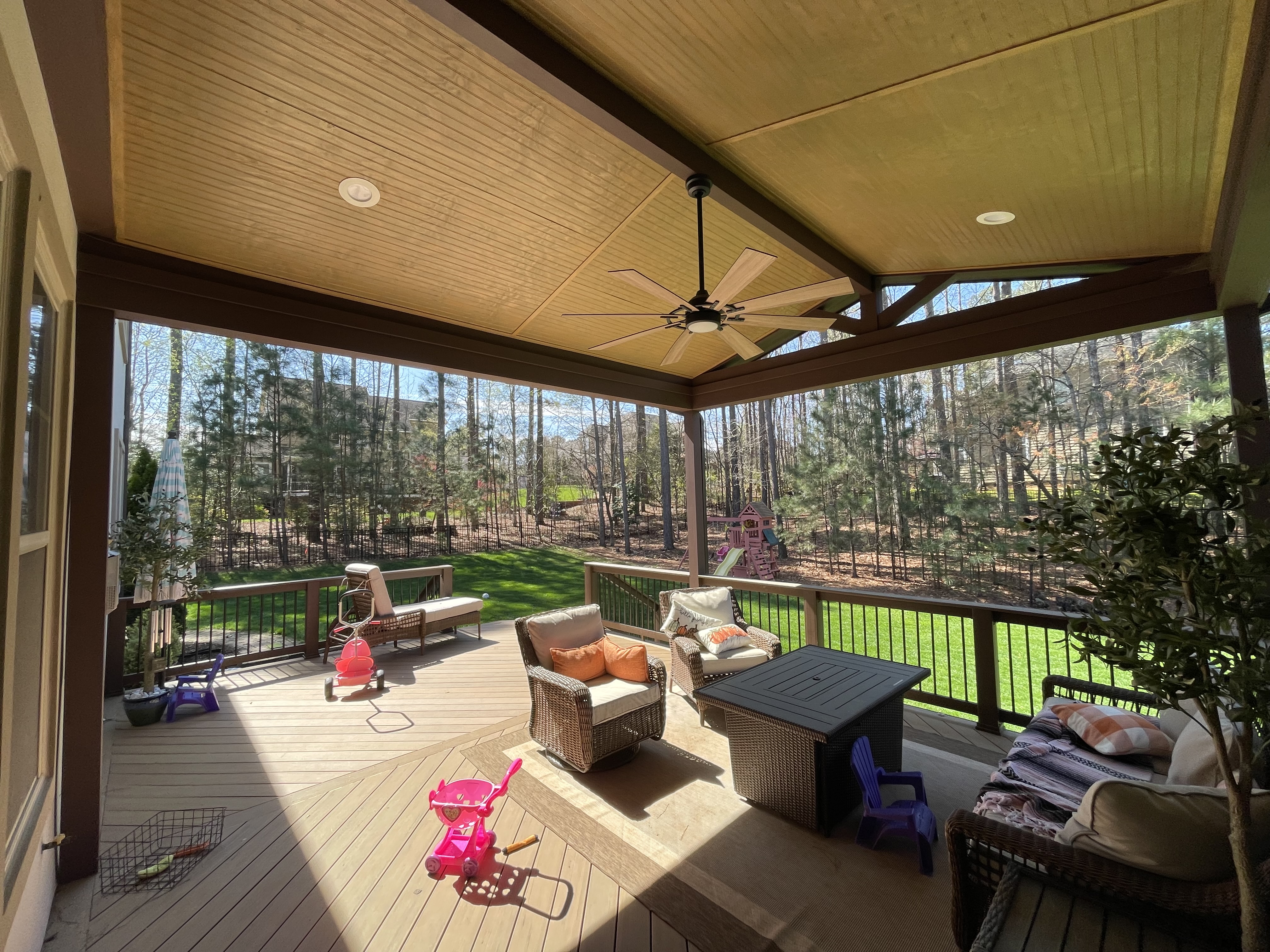 Open porch with large gable roof and composite decking overlooking a gorgeous charlotte, NC wooded backyard.