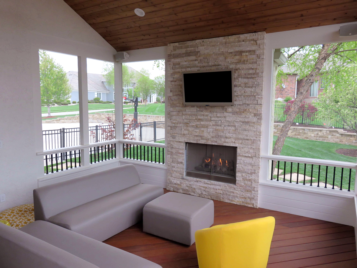 Outdoor fireplace on screen porch by Archadeck of Kansas City
