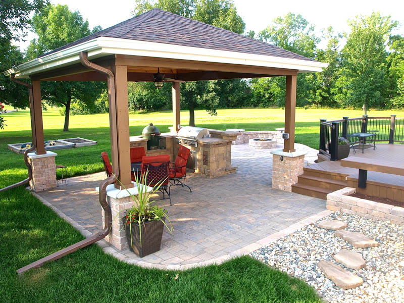 roofed pavilion with four posts over a stone patio