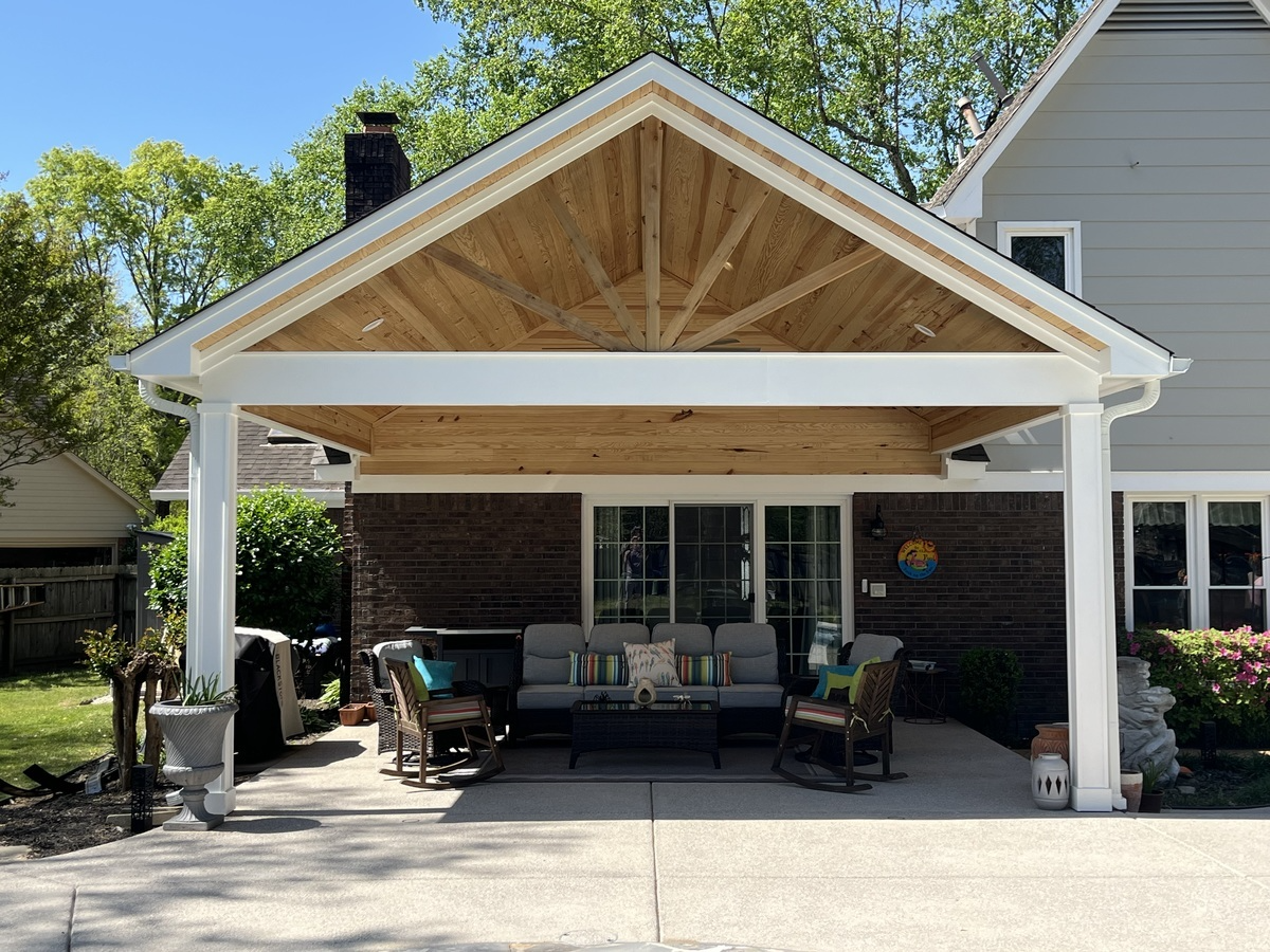 Covered outdoor patio with wood top and white trim