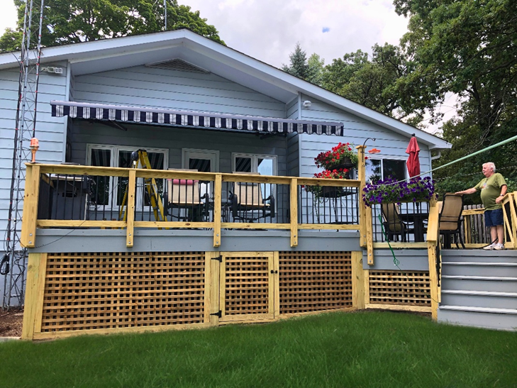 Wood deck in Lake Zurich with lattice skirting, multiple levels, and an awning.