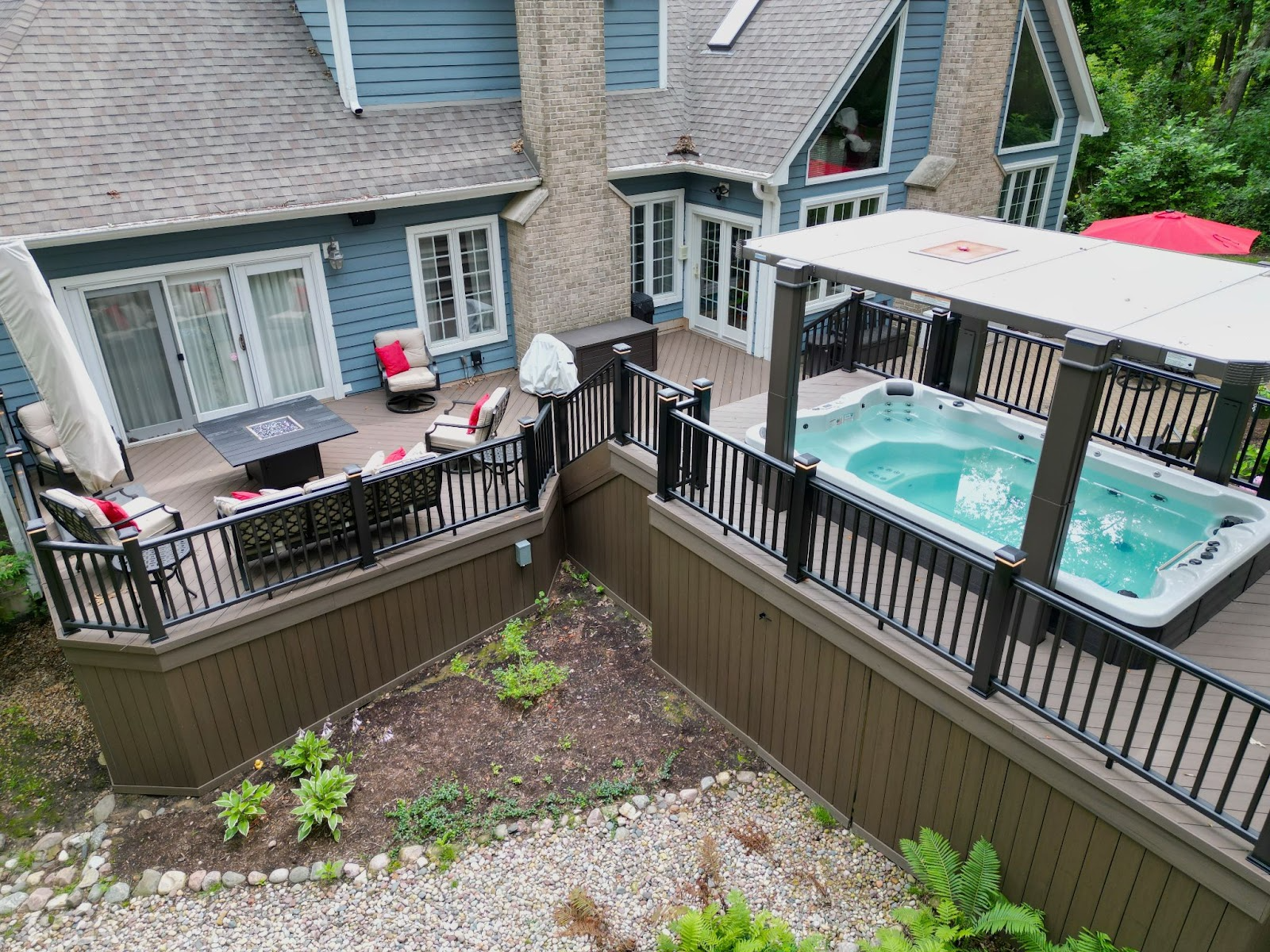 Custom patio with seating and a built in covered hot tub