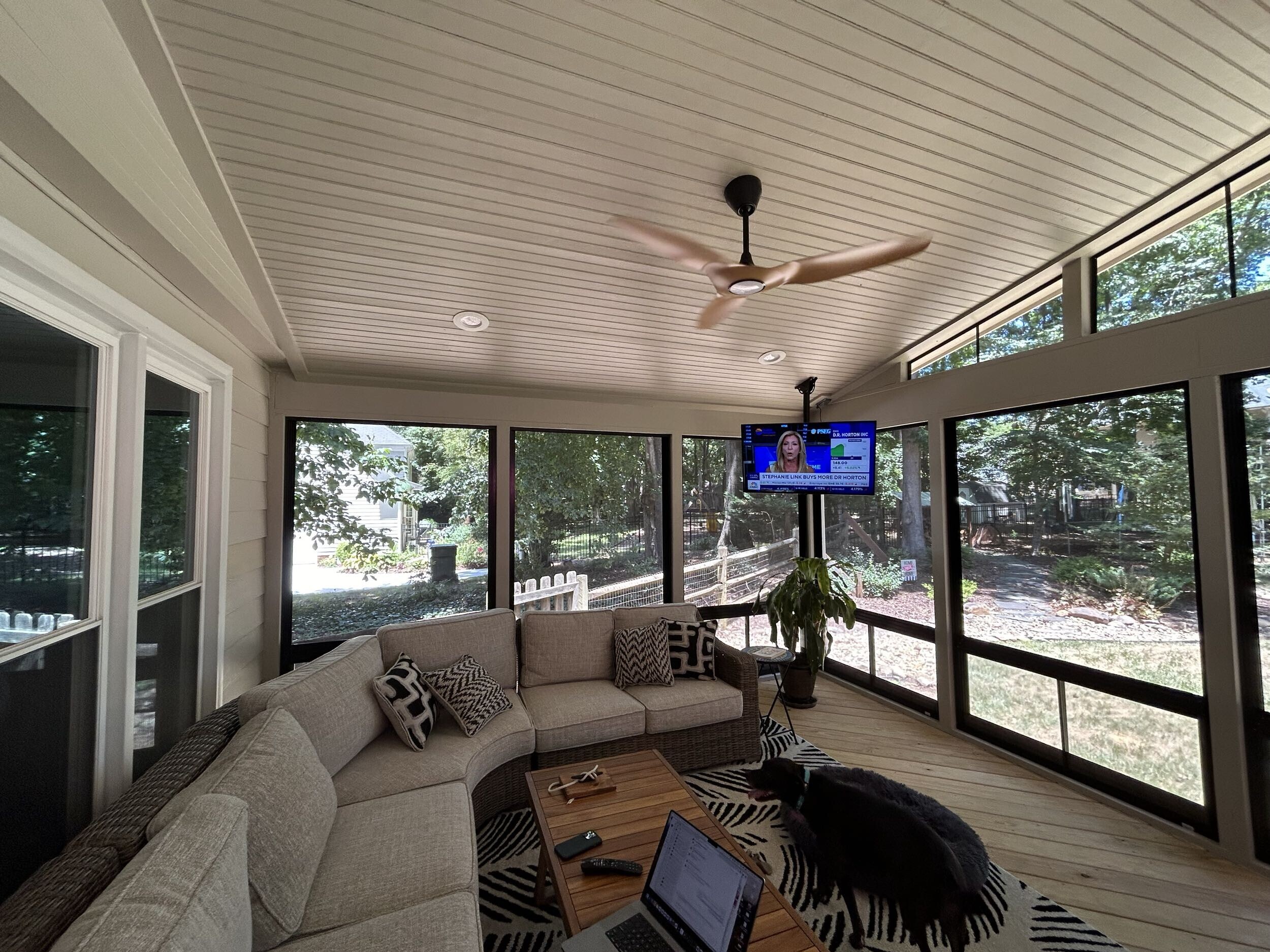 Sunroom with 4-track windows, sectional sofa, and tv in Charlotte, NC.