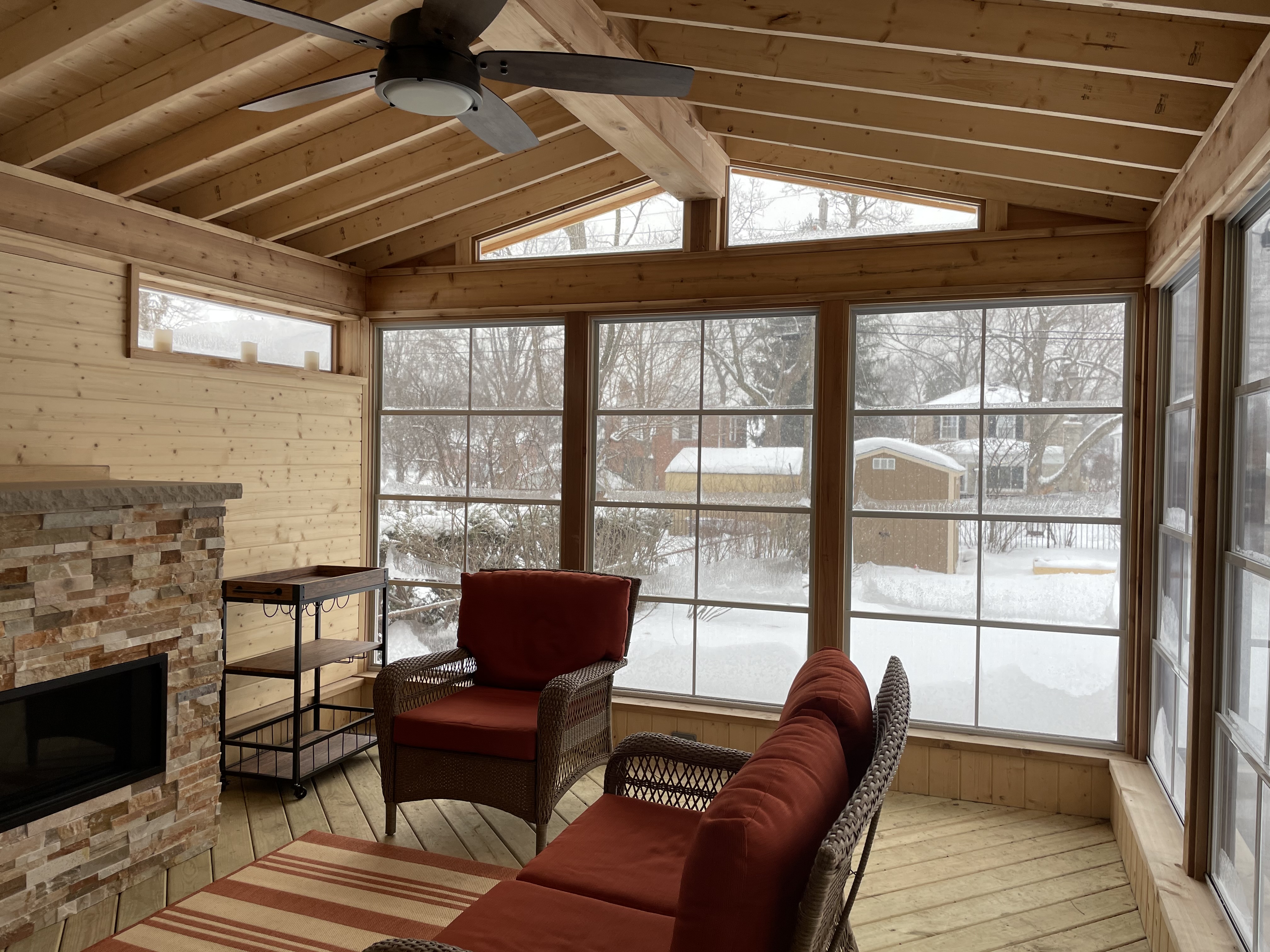 3 season room with 4-track windows overlooking a snow filled backyard in Arlington Heights, IL.