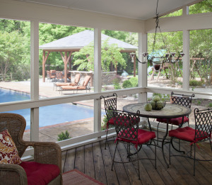 screened in porch with view of outdoor pool