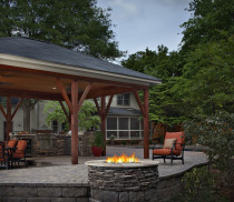 covered patio with chairs and firepit