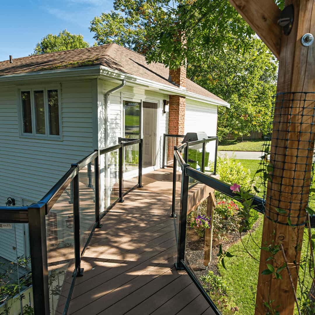 Curved walkway connecting house with the upper-level deck area looking towards the house