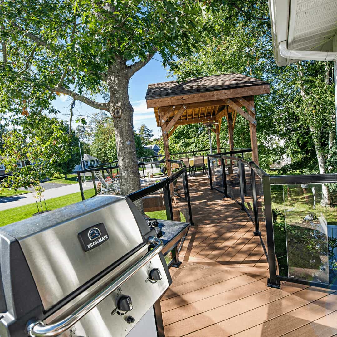 Curved walkway connecting house with the upper-level deck area looking towards the deck area