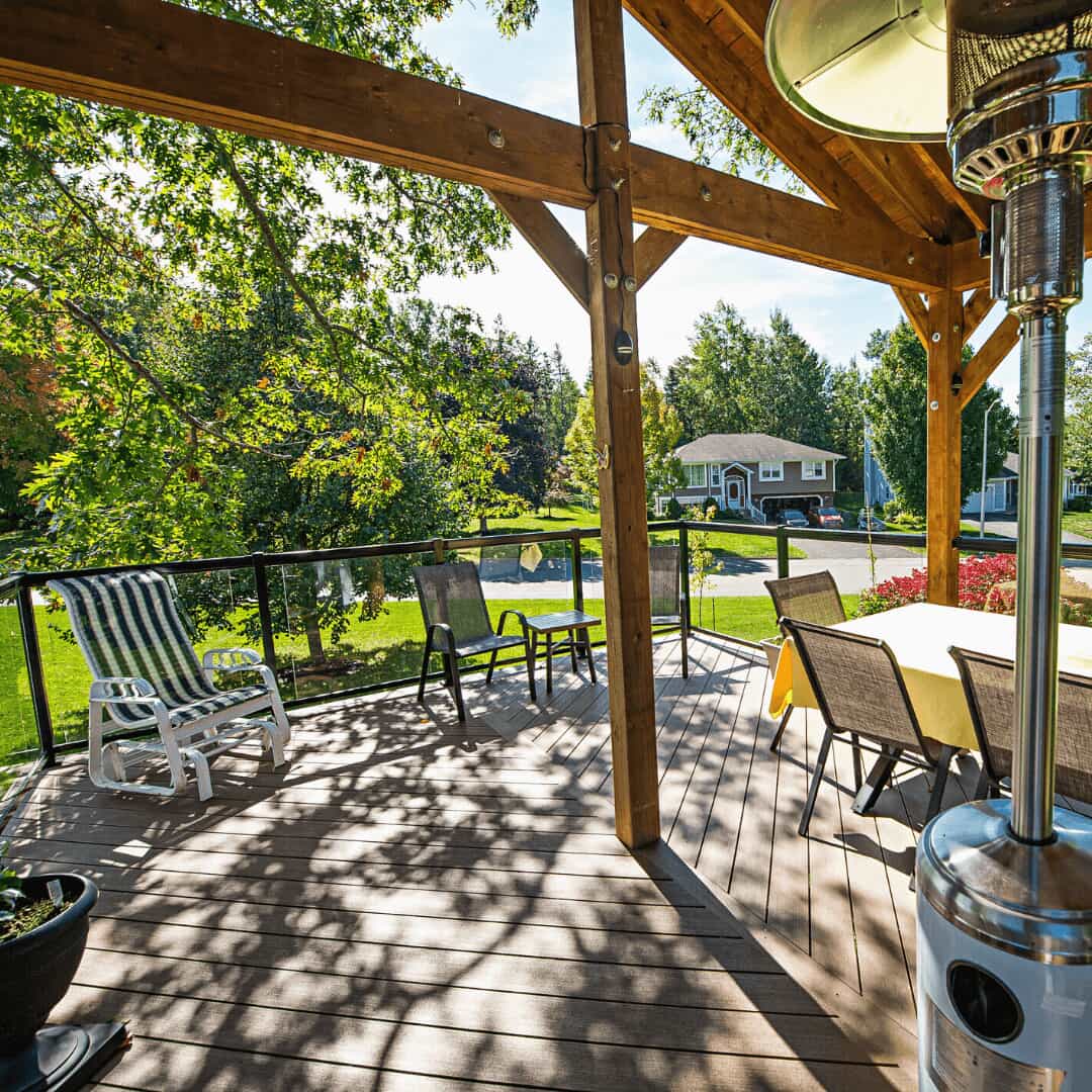 Photo of the upper-level deck and walkway taken from the backyard lawn