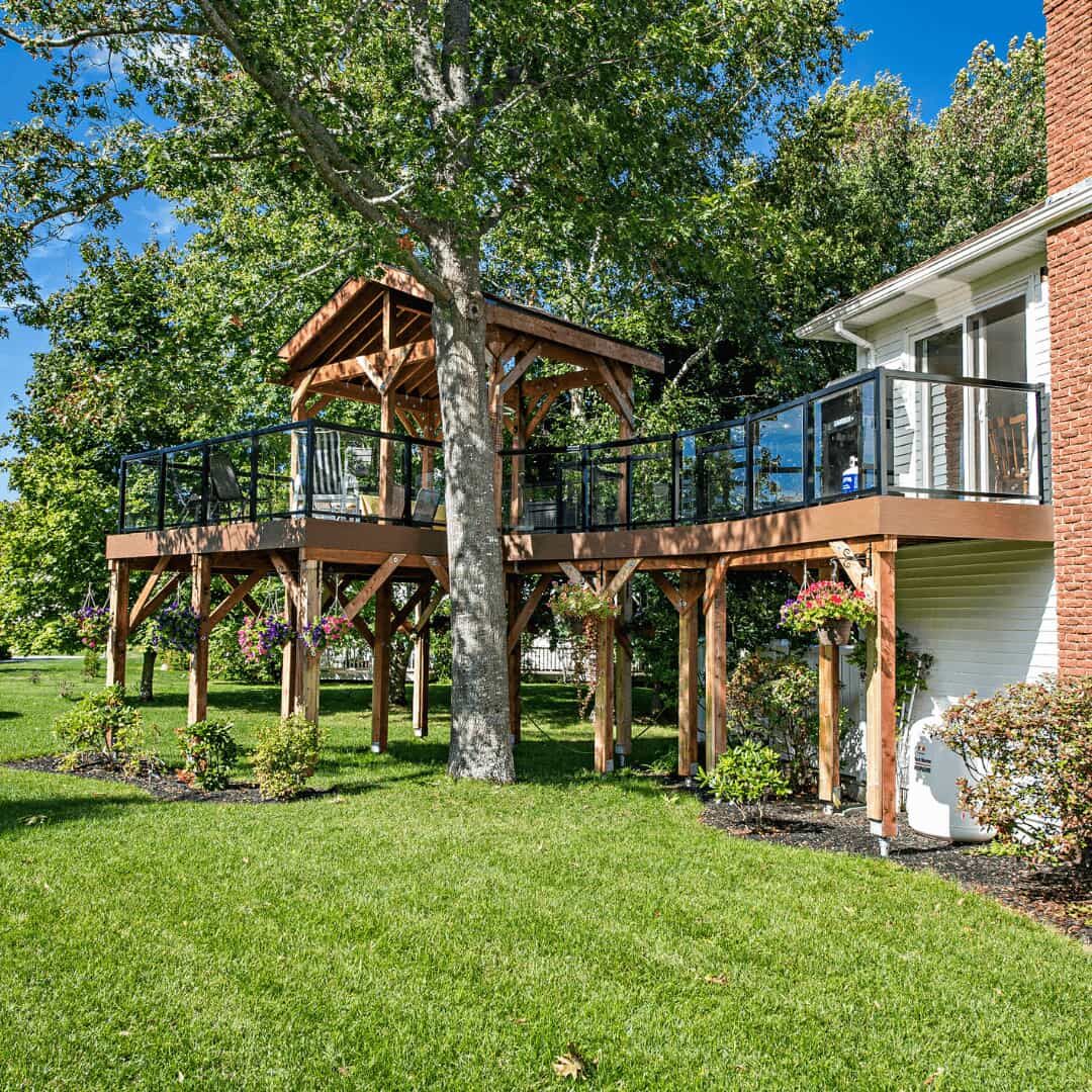 Side-view of the upper-level deck and walkway as seen from the backyard lawn