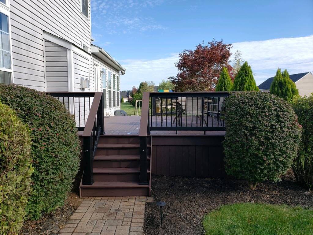 Backyard deck with railing and stairs