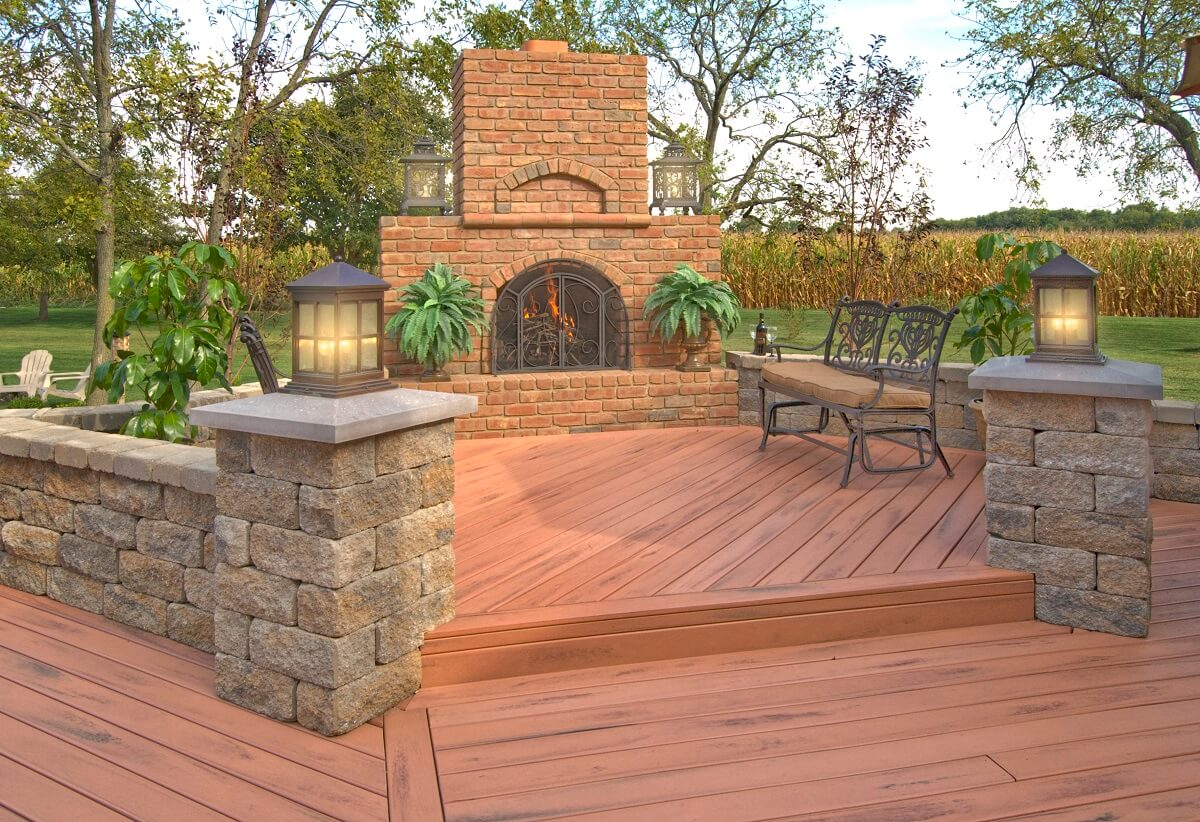 Composite deck with outdoor fireplace and seating wall