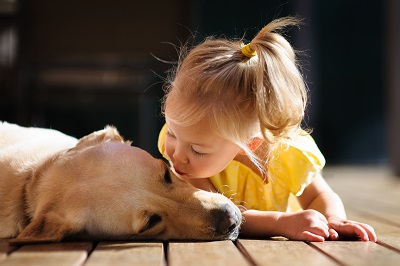 Kid kissing dog
