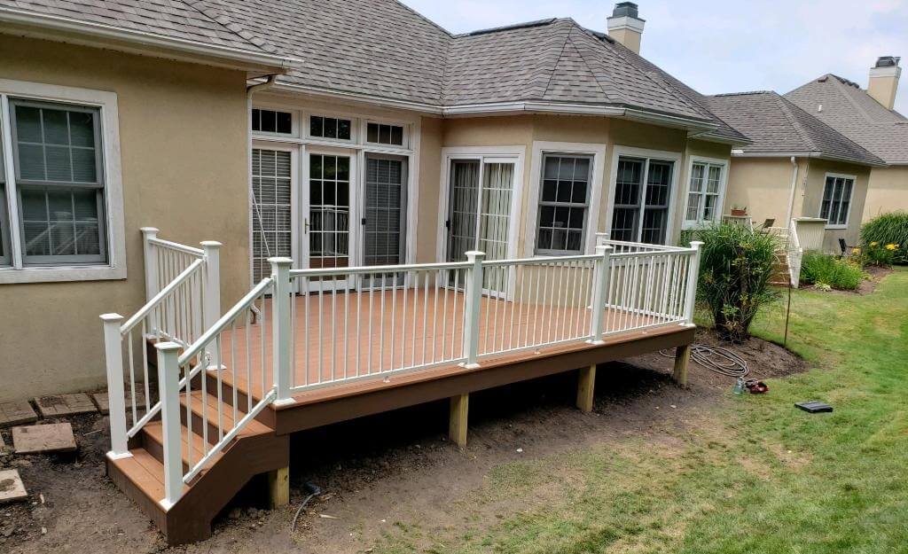 Backyard wood deck with white railing