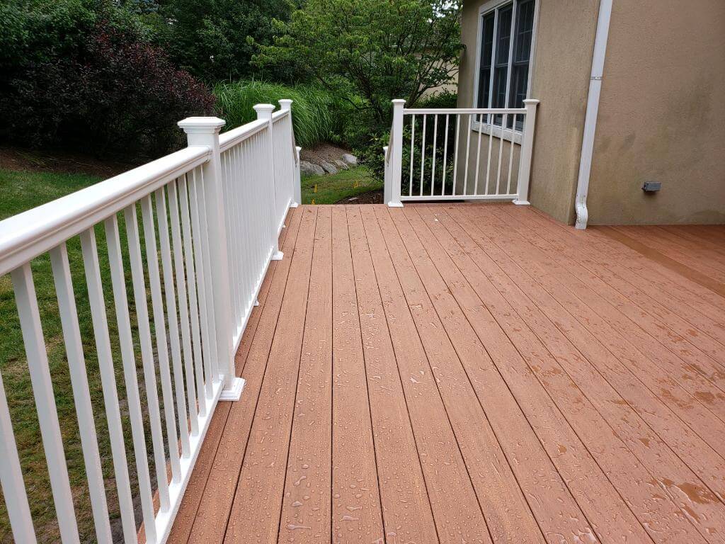 Backyard wood deck with white railing